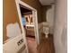 Bathroom area featuring a toilet and vanity adjacent to an open doorway at 2033 Aaron Pl, Clearwater, FL 33760