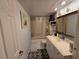 Bathroom with a tub, shower, toilet, and a vanity sink with white cabinets at 2033 Aaron Pl, Clearwater, FL 33760