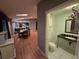 Bathroom features a toilet, sink and cabinet with an open living space beyond at 2033 Aaron Pl, Clearwater, FL 33760