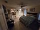 Bedroom with tile floors, ceiling fan, connected bathroom and closet at 2033 Aaron Pl, Clearwater, FL 33760
