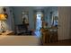 Bedroom with hardwood floors, and a blue accent wall and chair at 2033 Aaron Pl, Clearwater, FL 33760