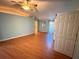 Bright bedroom with hardwood floors, two closets, and a ceiling fan providing comfort and functionality at 2033 Aaron Pl, Clearwater, FL 33760