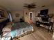 Bedroom with tile floors, ceiling fan, connected bathroom and closet, and a desk at 2033 Aaron Pl, Clearwater, FL 33760