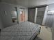 Bedroom with a grey mattress and minimal decor at 2033 Aaron Pl, Clearwater, FL 33760