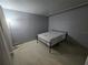 Empty bedroom with grey walls and minimal furnishings and single bed at 2033 Aaron Pl, Clearwater, FL 33760