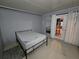 Bedroom with minimal furnishings, single bed, and sliding glass doors to the exterior at 2033 Aaron Pl, Clearwater, FL 33760