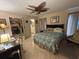 Cozy bedroom featuring tile flooring, a ceiling fan, and a large walk-in closet at 2033 Aaron Pl, Clearwater, FL 33760