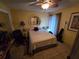 Cozy bedroom featuring tile flooring, a ceiling fan, and bright yellow walls at 2033 Aaron Pl, Clearwater, FL 33760