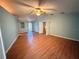 Large bedroom with light blue walls, hardwood floors, and a ceiling fan at 2033 Aaron Pl, Clearwater, FL 33760