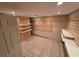 Spacious walk-in closet with shelving, tiled floor, and recessed lighting at 2033 Aaron Pl, Clearwater, FL 33760