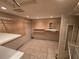 Spacious walk-in closet with shelving, tiled floor, and recessed lighting at 2033 Aaron Pl, Clearwater, FL 33760