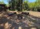 Outdoor fire pit area with seating and landscaping at 2033 Aaron Pl, Clearwater, FL 33760