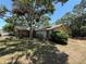 A single-story home surrounded by mature trees and with well-established landscaping at 2033 Aaron Pl, Clearwater, FL 33760