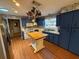 Kitchen with blue cabinets, butcher block island, stainless steel refrigerator and white countertops at 2033 Aaron Pl, Clearwater, FL 33760