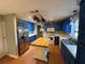 Spacious kitchen featuring blue cabinetry, a butcher block island, and stainless steel appliances at 2033 Aaron Pl, Clearwater, FL 33760