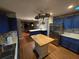 Bright kitchen features stainless steel appliances, butcher block central island and hardwood flooring at 2033 Aaron Pl, Clearwater, FL 33760