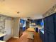 Kitchen with blue cabinets, butcher block island, stainless steel refrigerator and patterned wallpaper at 2033 Aaron Pl, Clearwater, FL 33760