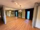 Spacious living room featuring wood floors, mirrored wall, chandelier, and recessed lighting at 2033 Aaron Pl, Clearwater, FL 33760