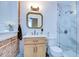 Bright bathroom boasting a marble-tiled shower, vanity, and exposed brick detail at 215 Central Ave # 2B, St Petersburg, FL 33701