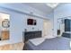 Bedroom features a large dresser, hardwood floors, and a glimpse into the en-suite bathroom at 215 Central Ave # 2B, St Petersburg, FL 33701