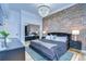Elegant bedroom with an exposed brick wall, chandelier, and a mirrored wardrobe at 215 Central Ave # 2B, St Petersburg, FL 33701