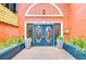 Charming exterior features a unique door and manicured potted plants at 215 Central Ave # 2B, St Petersburg, FL 33701