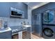 A chef's kitchen with modern appliances including a washer and dryer at 215 Central Ave # 2B, St Petersburg, FL 33701