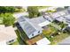 Overhead view of the home with view of roof, the screened in back patio, yard and mature landscaping at 21608 Wytheville Way, Lutz, FL 33549