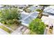 Overhead view of home with mature trees in established neighborhood, garage, driveway, and lawn at 21608 Wytheville Way, Lutz, FL 33549