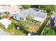 An aerial view of a backyard with a fence, landscaping, and a screened-in patio at 21608 Wytheville Way, Lutz, FL 33549
