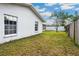 The exterior of the house is white with a window and the lawn is green at 21608 Wytheville Way, Lutz, FL 33549