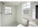 Simple bathroom design features a shower, toilet, and vanity, bathed in natural light at 21608 Wytheville Way, Lutz, FL 33549