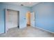 Light-blue bedroom with an open closet and white door at 21608 Wytheville Way, Lutz, FL 33549
