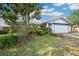 Charming single Gathering home with a two car garage, mature trees, and lush landscaping at 21608 Wytheville Way, Lutz, FL 33549