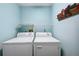 Laundry room with side by side washer and dryer with blue walls at 21608 Wytheville Way, Lutz, FL 33549