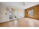 Airy living room boasts wood floors, neutral walls, and French doors to the backyard at 21608 Wytheville Way, Lutz, FL 33549