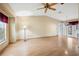 Bright and airy living room with wood floors and a ceiling fan, offering a comfortable living space at 21608 Wytheville Way, Lutz, FL 33549