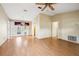 Bright and airy living room with wood floors and a ceiling fan, offering a comfortable living space at 21608 Wytheville Way, Lutz, FL 33549