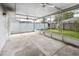 Spacious screened patio with ceiling fans overlooking a fenced backyard at 21608 Wytheville Way, Lutz, FL 33549