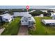 Inviting two-story home featuring a metal roof, two-car garage, and lush landscaping at 24197 Treasure Island Blvd., Punta Gorda, FL 33955