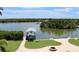 Backyard with a covered boat dock and patio area offers a serene waterfront experience at 24197 Treasure Island Blvd., Punta Gorda, FL 33955