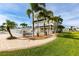 Home exterior with landscaped yard, green lawn, and pool at 24197 Treasure Island Blvd., Punta Gorda, FL 33955