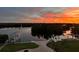 Sunset view over backyard, featuring a boat dock, patio, and serene waterfront landscape at 24197 Treasure Island Blvd., Punta Gorda, FL 33955