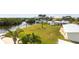 Large backyard features a lush lawn, palm trees and waterfront views at 24197 Treasure Island Blvd., Punta Gorda, FL 33955