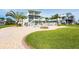 Home exterior featuring a green lawn, fire pit, and pool at 24197 Treasure Island Blvd., Punta Gorda, FL 33955