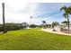 Expansive backyard with well-manicured lawn, boat dock, and brick-paved patio area at 24197 Treasure Island Blvd., Punta Gorda, FL 33955