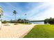 Landscaped backyard features a boat dock, fire pit, and a patio with outdoor seating at 24197 Treasure Island Blvd., Punta Gorda, FL 33955