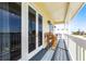 Covered balcony with seating, overlooking waterfront views and manicured backyard at 24197 Treasure Island Blvd., Punta Gorda, FL 33955