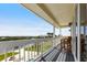 Spacious balcony with beautiful views of the pool, water, and lush landscaping at 24197 Treasure Island Blvd., Punta Gorda, FL 33955