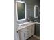 Elegant bathroom with updated vanity, stylish mirror and glass shower enclosure at 24197 Treasure Island Blvd., Punta Gorda, FL 33955